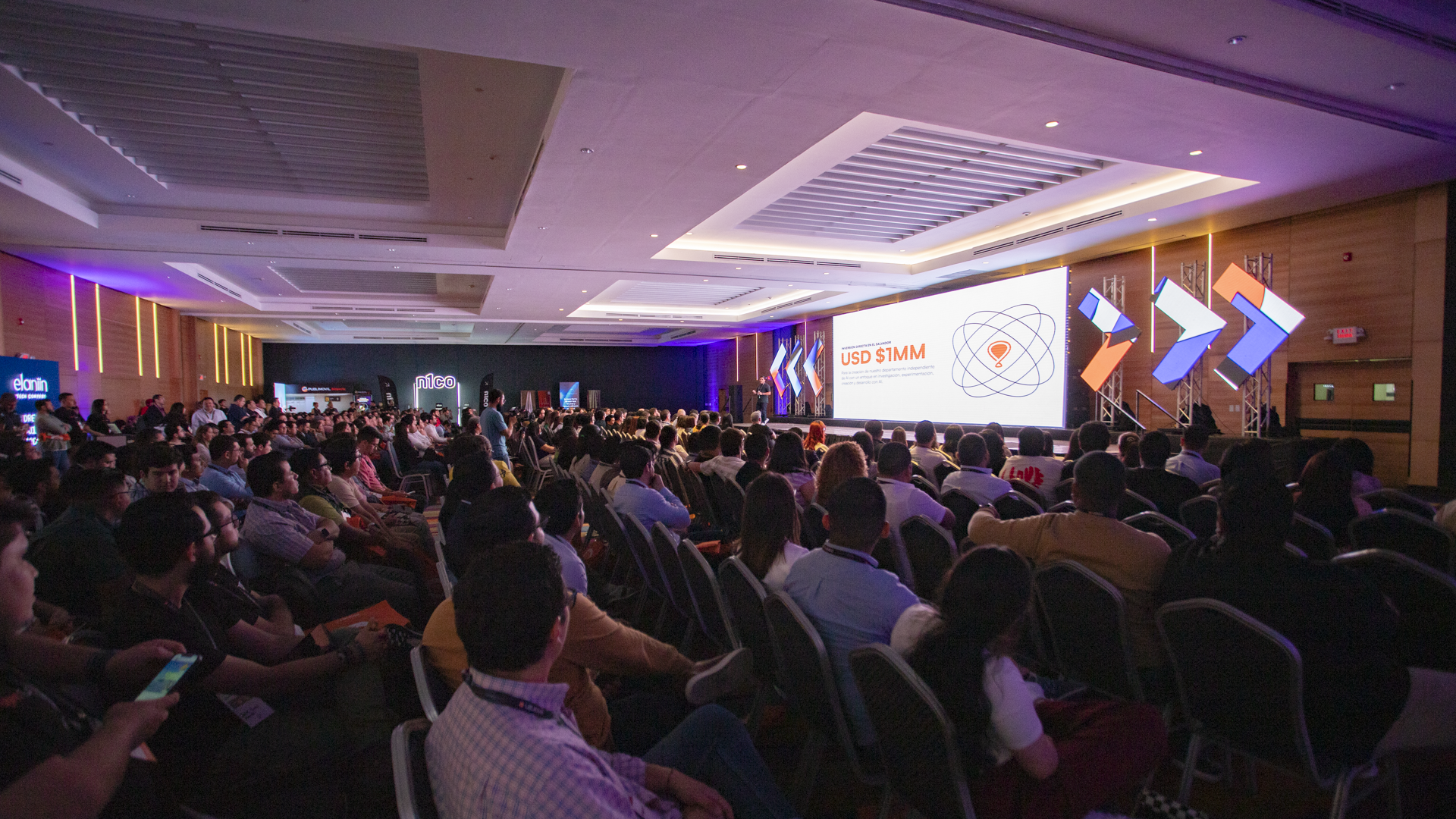 Elaniin AI '24 — full auditorium with USD $1MM investment slide